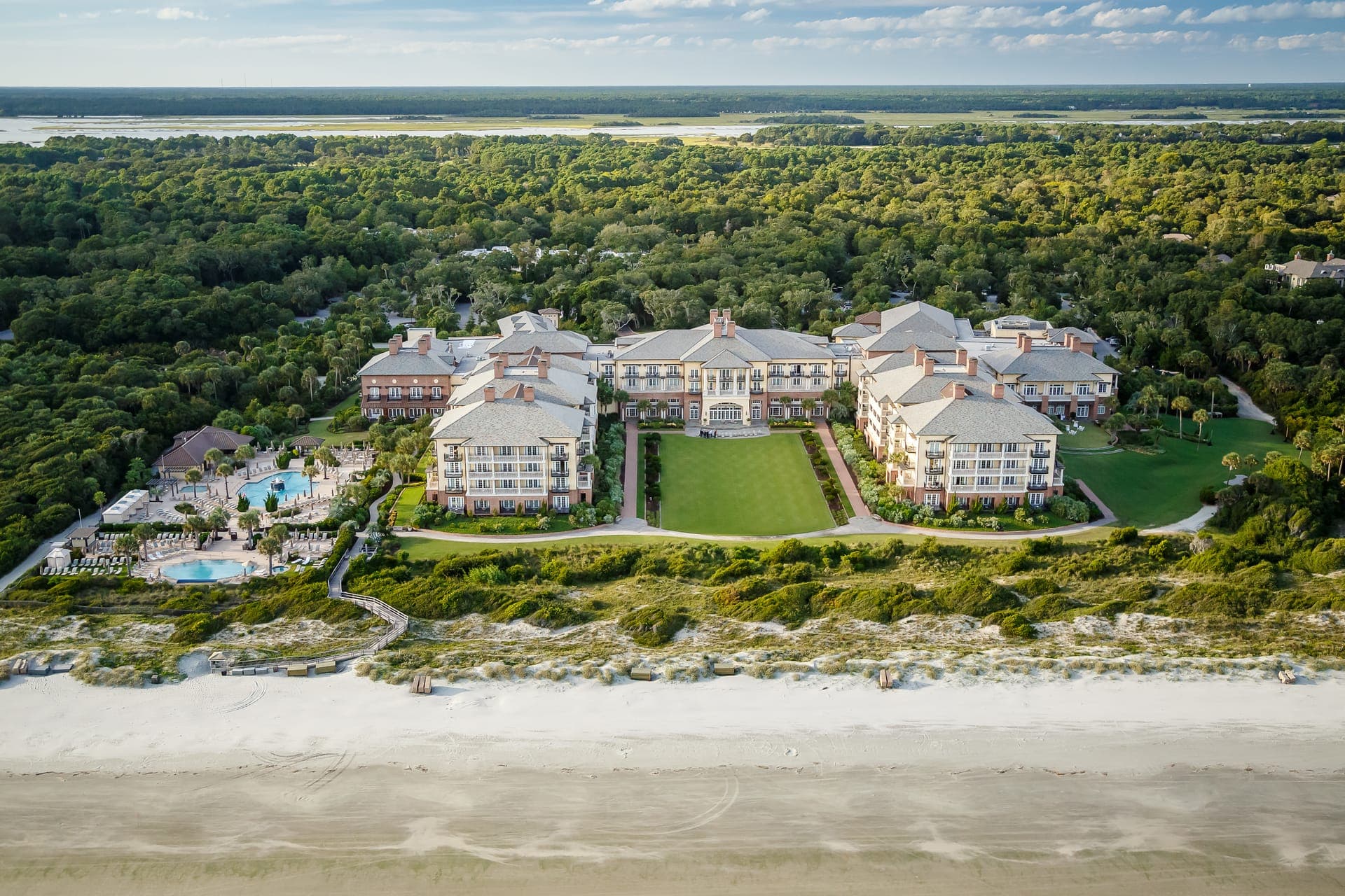 Aerial view of The Sanctuary at Kiawah Island Golf Resort from the beachfront, framed by maritime forest