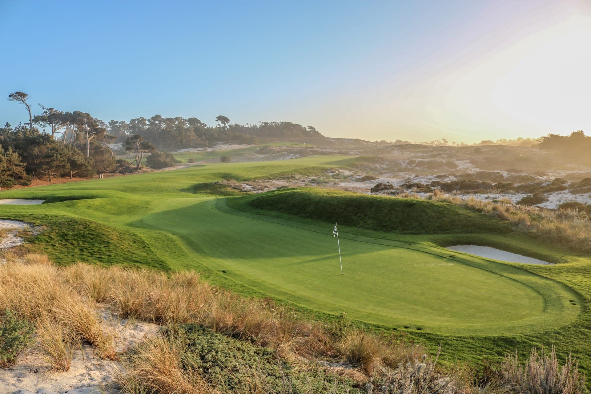Lone flag on Spyglass Hill’s hole 4 green carved into the dunes at dawn