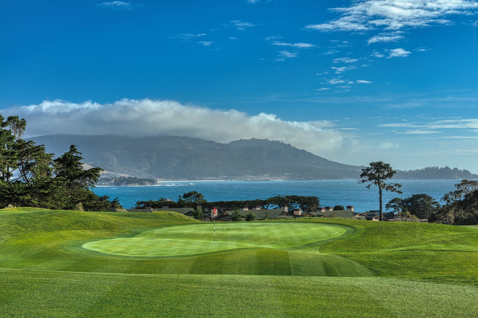 The 1st hole at The Hay Short Course with Carmel Bay and Point Lobos hills filling the horizon