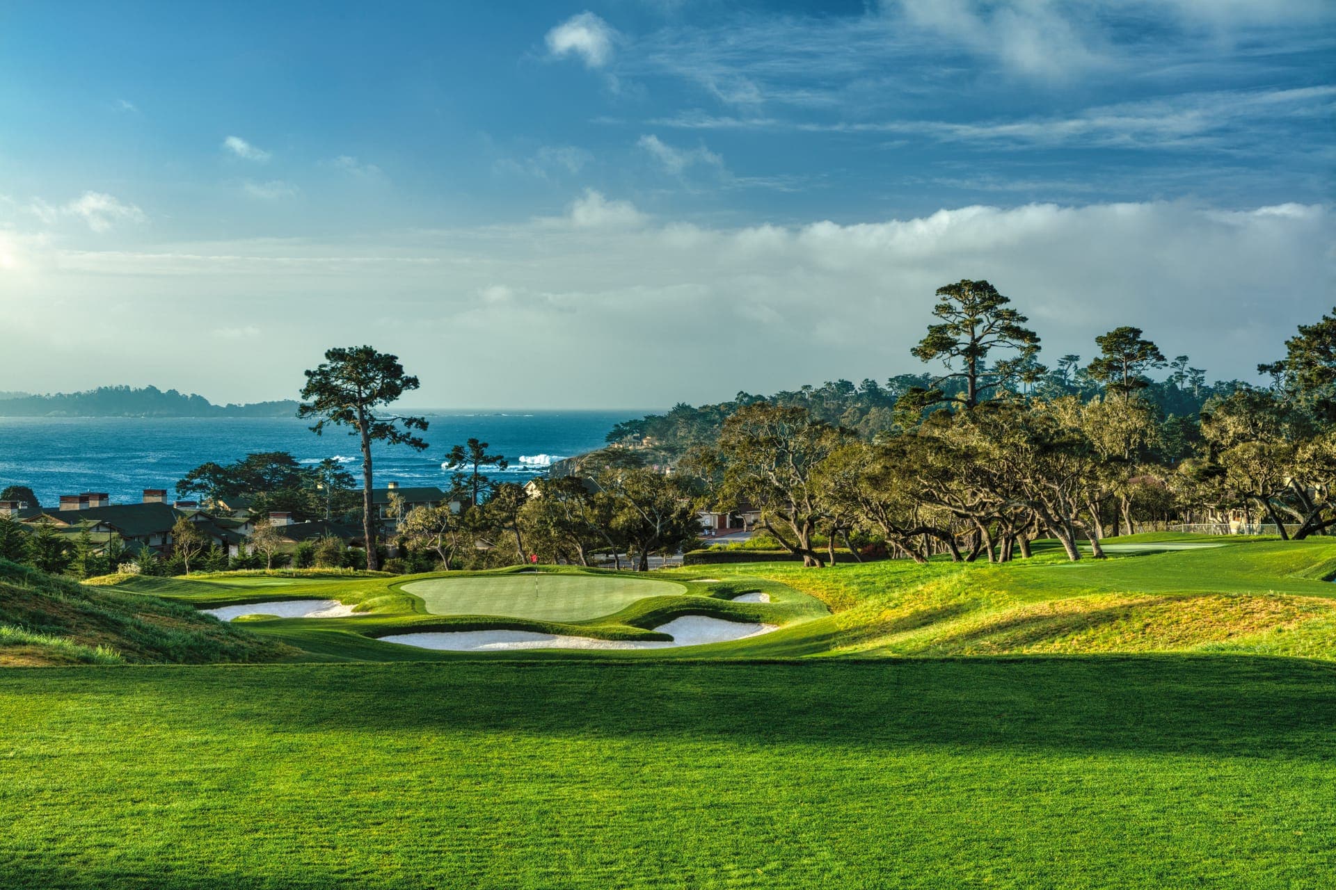 Backlit oaks framing a bunkered green on the 2nd hole at The Hay Short Course, Pebble Beach