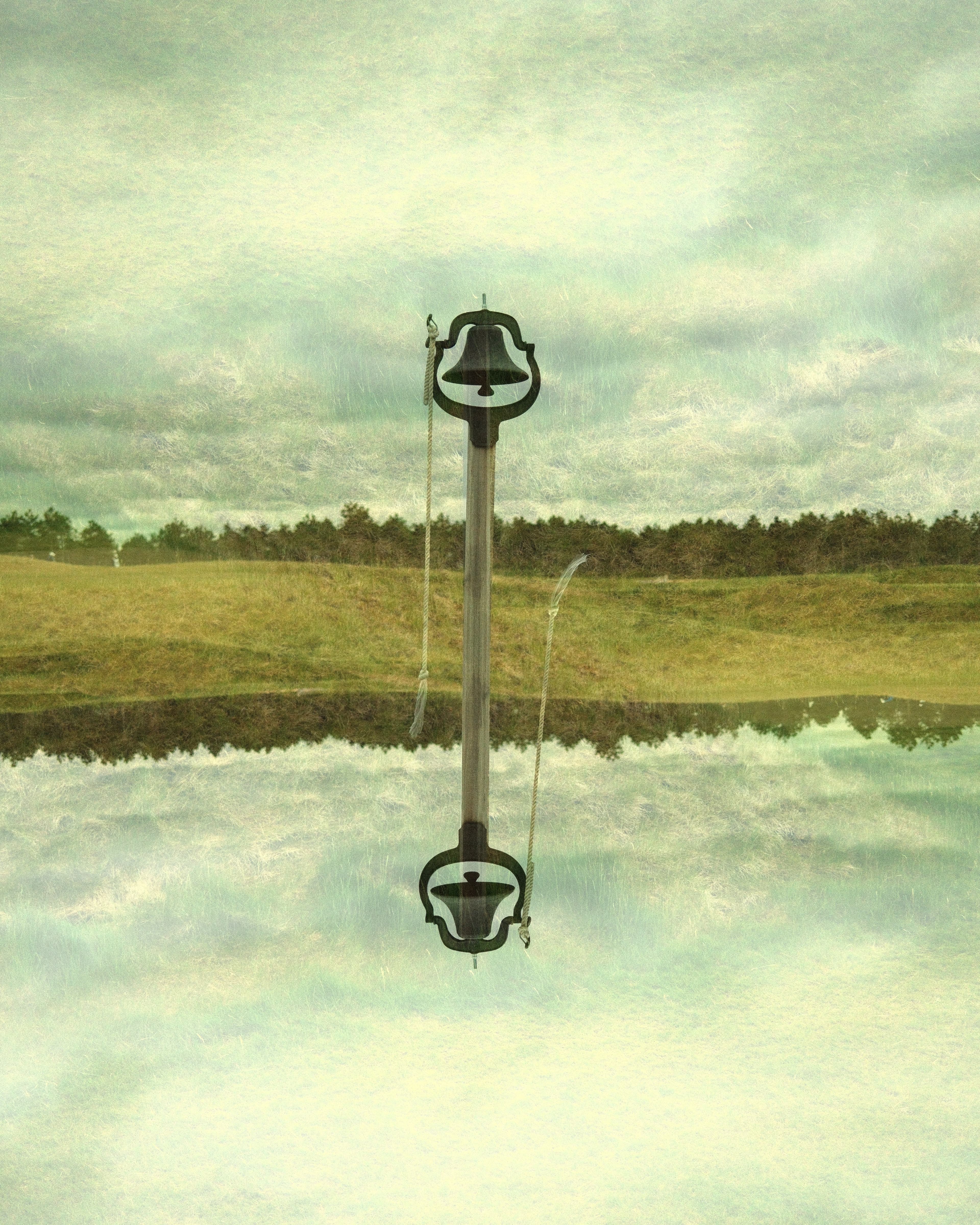 Aerial view of The Lido at Sand Valley at golden hour, a recreated C.B. Macdonald design showing sculpted green, pot bunkering, and water hazard